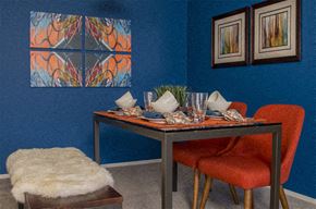 Sterling Heights apartment for rent - a dining room with a table and chairs and a painting