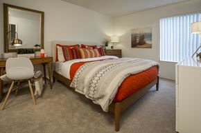 Sterling Heights apartment for rent - a bedroom with a bed and a desk with a chair