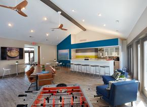 Sterling Heights apartment for rent - a clubhouse with a pool table and chairs and a kitchen with a blue accent wall