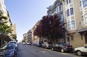 San Francisco apartment for rent - A street with cars parked on both sides and buildings on the side.