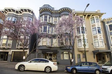 San Francisco apartment for rent - A row of three-story buildings with a car parked in front of them.