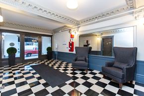 San Francisco apartment for rent - A black and white checkered floor in a room with two chairs and a fire extinguisher.
