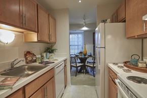 Farmington Hills apartment for rent - A kitchen with wooden cabinets and a white refrigerator.