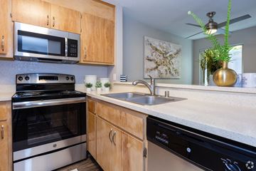Citrus Heights apartment for rent - A kitchen with wooden cabinets and stainless steel appliances.