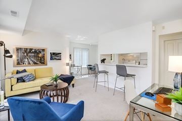 Novi apartment for rent - A living room with a yellow couch and blue chairs.