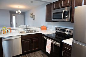 Morrisville apartment for rent - Renovated kitchen with dark cabinetry and stainless steel appliances.