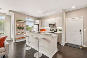 Ann Arbor townhouse for rent - A kitchen with white cabinets and a bar area.