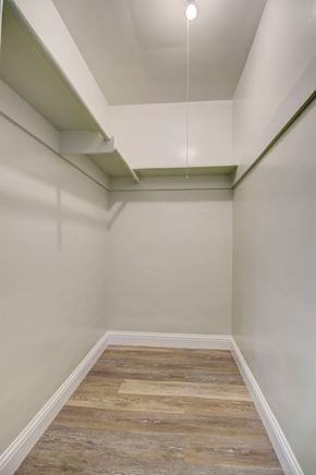 Sacramento apartment for rent - A long, narrow hallway with wood flooring and white walls.