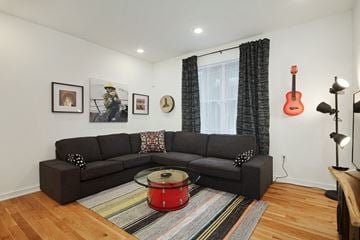 Philadelphia apartment for rent - a living room with a couch and a guitar on the wall