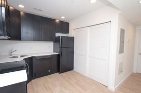 Philadelphia apartment for rent - a kitchen with black cabinets and a black refrigerator