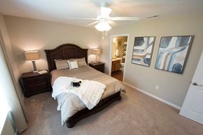 Louisville apartment for rent - a bedroom with a bed and a ceiling fan