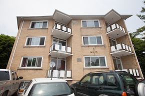 Kingston apartment for rent - a apartment building with cars parked in front of it