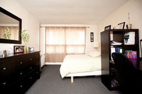 Kingston apartment for rent - a bedroom with a bed and a dresser in it