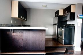 Kingston apartment for rent - a kitchen with a stove refrigerator and a sink
