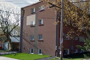 Kingston apartment for rent - a brick building with windows on the side of a street