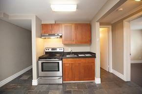 Kingston apartment for rent - a kitchen with stainless steel appliances and wooden cabinets