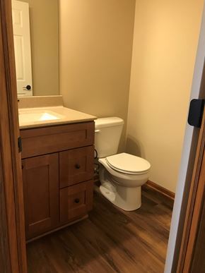 Lincoln house for rent - A white toilet sits in a bathroom next to a sink.