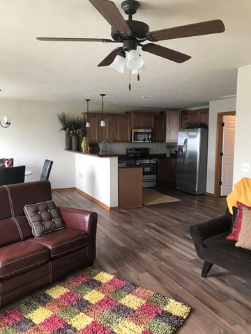 Lincoln house for rent - A brown leather couch sits in a kitchen with a ceiling fan.