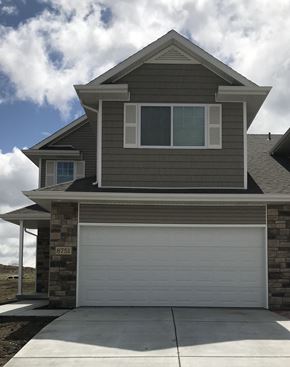 Lincoln house for rent - A two-story house with a garage door and a window.