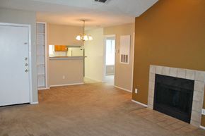 San Antonio apartment for rent - an empty living room with a fireplace and a kitchen