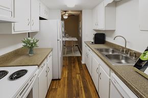 Omaha apartment for rent - a kitchen with white cabinets and counters and a sink