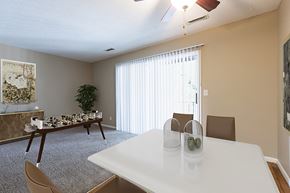 Omaha apartment for rent - a dining room with a white table and chairs and a large window