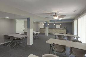Omaha apartment for rent - a conference room with tables and chairs and a ceiling fan