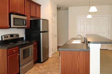 Harrisburg apartment for rent - a kitchen with stainless steel appliances and wooden cabinets
