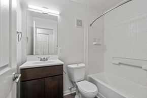 Fort Wayne apartment for rent - A white bathroom with a toilet, sink, and bathtub.