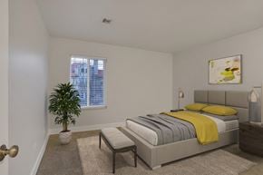 Denver apartment for rent - a bedroom with a bed and a plant and a window