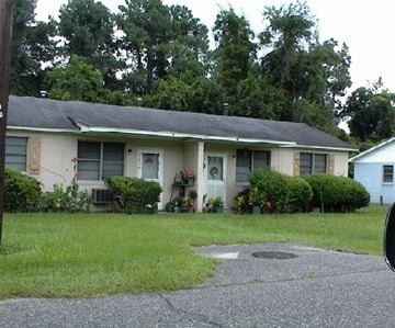 Beaufort - Coming Available 9/13/26 apartment for rent - A house with a green lawn and a grey roof.