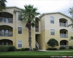 Oviedo apartment for rent - a large building with a palm tree in front of it