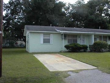 Beaufort - Available Now apartment for rent - A house with a green front yard and a concrete walkway leading to the front door.