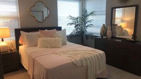 Oklahoma City apartment for rent - a bedroom with a bed and a mirror and a plant
