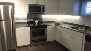 Oklahoma City apartment for rent - a kitchen with stainless steel appliances and white cabinets