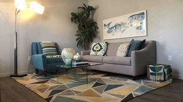 Oklahoma City apartment for rent - a living room with a couch and a chair and a rug