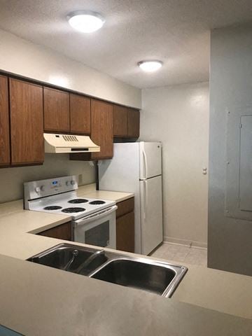 Beaufort - Coming Available 7/14/26 apartment for rent - A kitchen with a stove, oven, and refrigerator.