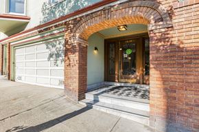 San Francisco apartment for rent - A house with a brown archway and a glass door.