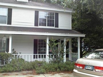 Port Royal - Coming Available 10/31/26 apartment for rent - A white house with a car parked in front.