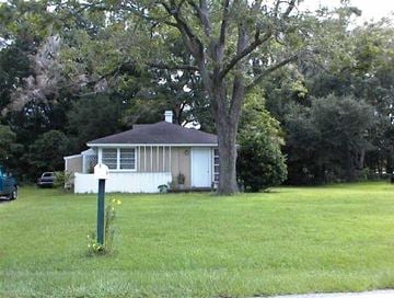 Port Royal - Coming Available 8/1/26 apartment for rent - A white house with a brown roof is surrounded by green trees.