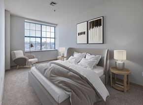 Philadelphia apartment for rent - A bedroom with a large bed and a window overlooking the water.