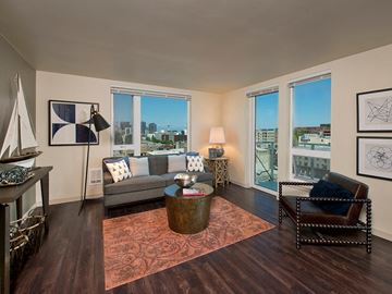 Seattle apartment for rent - a living room with a couch and a view of the city
