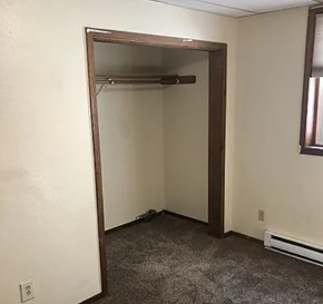Fargo apartment for rent - A room with a white wall and a doorway leading to another room.