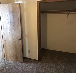 Fargo apartment for rent - A room with a wooden door and a white wall.