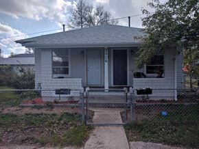 Cheyenne apartment for rent - a small white house with a fence in front of it
