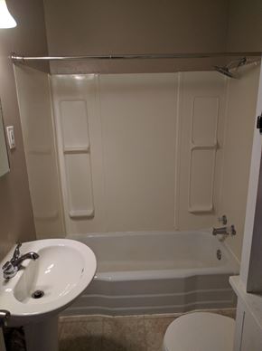 Cheyenne apartment for rent - a bathroom with a sink and a tub and a toilet