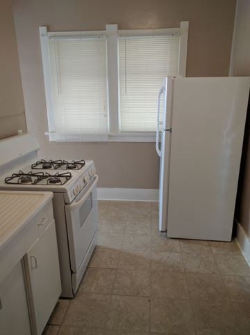 Cheyenne apartment for rent - an empty kitchen with a stove and a refrigerator