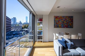 South Boston apartment for rent - a living room with a couch and a balcony overlooking the city