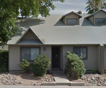 Tucson house for rent - A house with a grey roof and a black door.