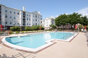 College Park apartment for rent - a swimming pool with an apartment building in the background